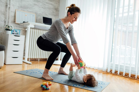 Young fit mom doing exercise with baby
